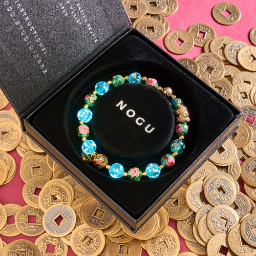 Sea Dragon bracelet with teal firefly glass and enamel lotus beads, 18k gold serpent charm in NOGU box with Chinese coins